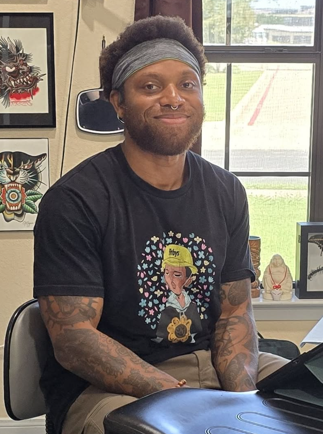 Qwami Tucker tattoo artist at work at Bangarang Tattooing Company